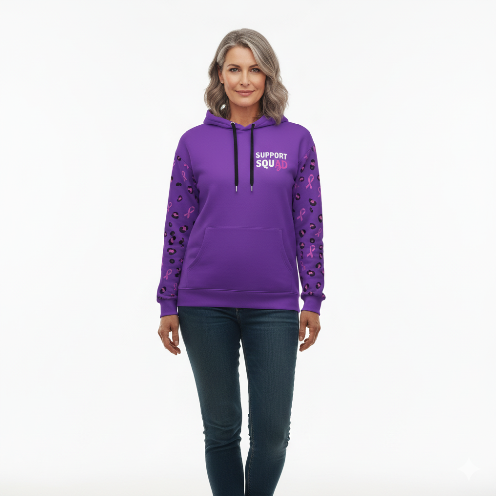 Woman wearing a purple hoodie with text and pink ribbons on sleeves against a white background