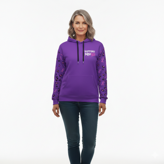 Woman wearing a purple hoodie with text and pink ribbons on sleeves against a white background